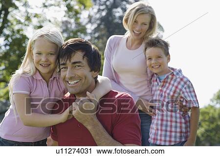 A family portrait in the park View Large Photo Image Stock Image - A family portrait in the park. Fotosearch