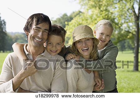 Stock Photo - A family portrait in the park. Fotosearch