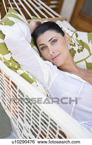 Stock Photograph - A female beauty resting in a hammock. Fotosearch