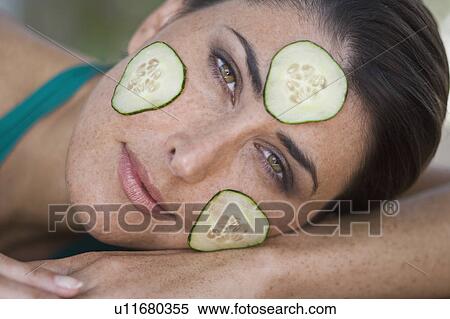Stock Photography - A female beauty with cucumber slices. Fotosearch