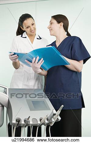 Stock Photograph - A female dentist and dental nurse. Fotosearch
