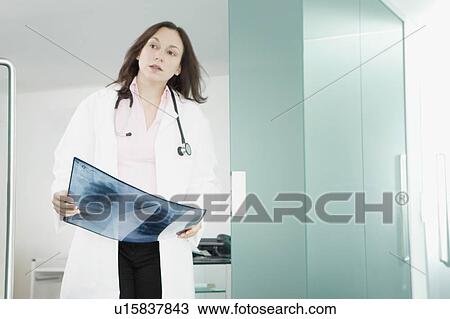 Stock Image - A female doctor holding an x-ray. Fotosearch