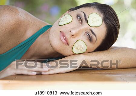 A female with cucumber on her face View Large Photo Image Stock Image - A female with cucumber on her face. Fotosearch