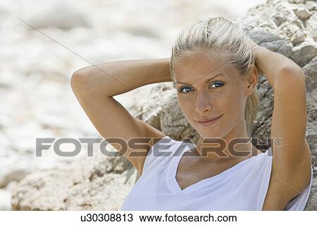 A female with her hands behind her head View Large Photo Image Stock Image - A female with her hands behind her head. Fotosearch
