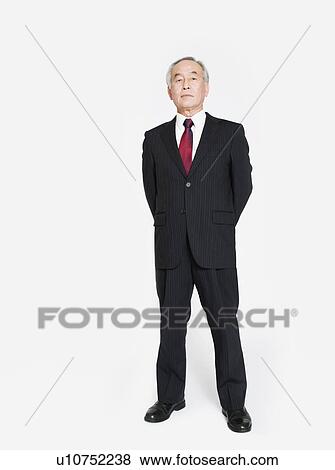 Stock Photo - A full length portrait of an Asian man. Fotosearch