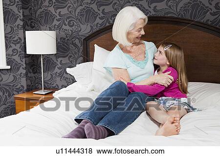 A grandmother and granddaughter hugging View Large Photo Image Stock Photo - A grandmother and granddaughter hugging. Fotosearch