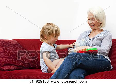 Stock Photograph - A grandmother playing with her grandson. Fotosearch