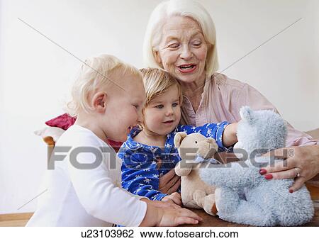 A grandmother playing with two toddlers View Large Photo Image Stock Image - A grandmother playing with two toddlers. Fotosearch