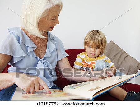 Stock Image - A grandmother reading to her grandson. Fotosearch