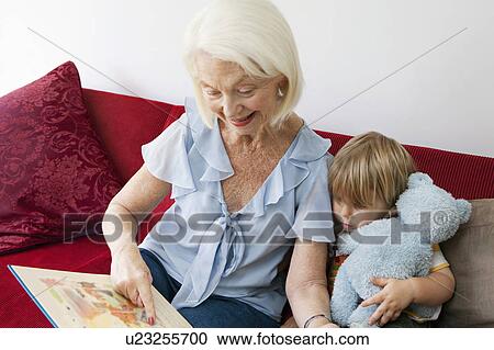 A grandmother reading to her grandson View Large Photo Image Stock Image - A grandmother reading to her grandson. Fotosearch
