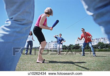 A group playing baseball in a park View Large Photo Image Picture - A group playing baseball in a park. Fotosearch