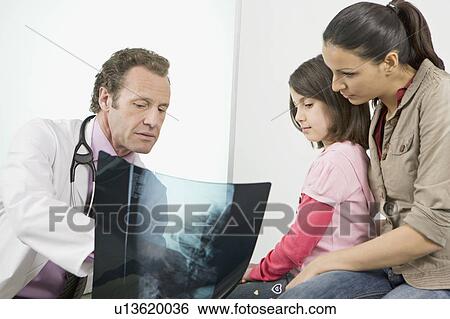 A male doctor showing patients an x-ray View Large Photo Image Stock Photograph - A male doctor showing patients an x-ray. Fotosearch