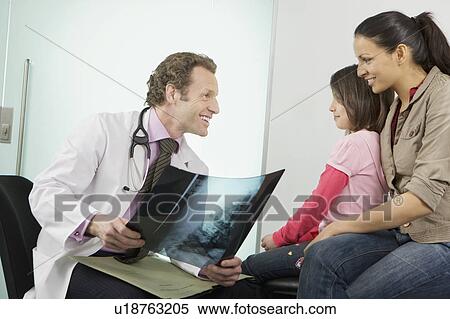 A male doctor showing patients an x-ray View Large Photo Image Stock Photography - A male doctor showing patients an x-ray. Fotosearch
