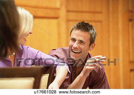 Stock Photo - A man laughing with course mates. Fotosearch