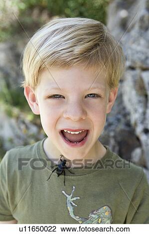 Stock Image - A portrait of a boy with a beetle. Fotosearch