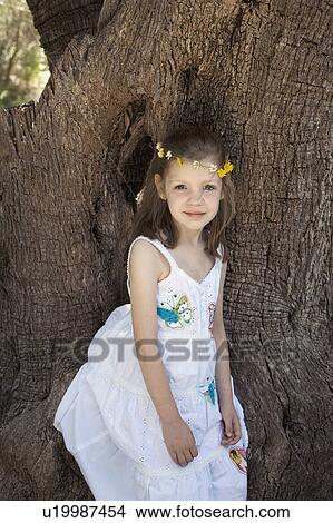 A portrait of a girl by a tree View Large Photo Image Picture - A portrait of a girl by a tree. Fotosearch