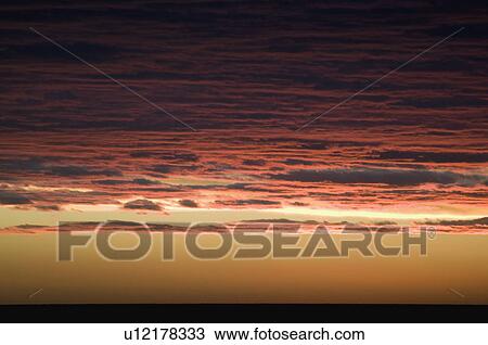 Stock Image - A red sky at sunset. Fotosearch