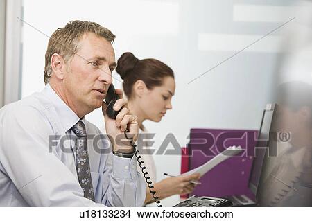 Picture - A senior business man on the phone. Fotosearch