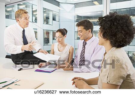 A senior male heads a business meeting View Large Photo Image Stock Photo - A senior male heads a business meeting. Fotosearch