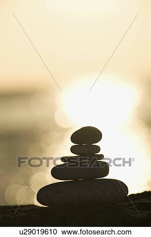 A stone stack against a setting sun View Large Photo Image Stock Image - A stone stack against a setting sun. Fotosearch