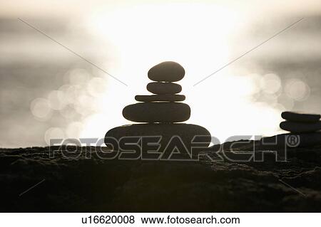 A stone stack against a setting sun View Large Photo Image Stock Photo - A stone stack against a setting sun. Fotosearch
