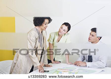 Stock Image - A voyeuristic shot of a meeting. Fotosearch