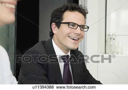 A young business man in a meeting View Large Photo Image Stock Photo - A young business man in a meeting. Fotosearch