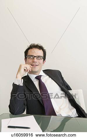 A young business man thinking View Large Photo Image Stock Photograph - A young business man thinking. Fotosearch