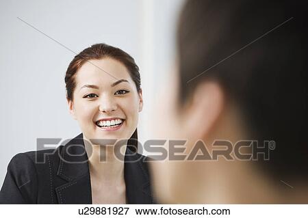 A young businesswoman talking View Large Photo Image Stock Photo - A young businesswoman talking. Fotosearch