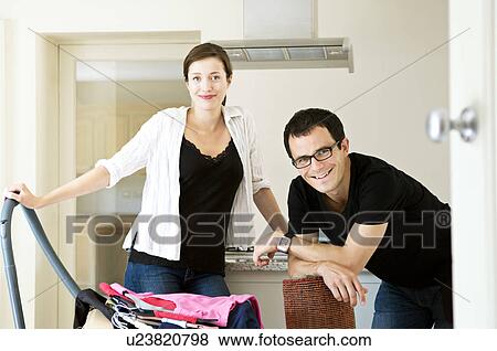 A young couple doing domestic chores View Large Photo Image Stock Photo - A young couple doing domestic chores. Fotosearch