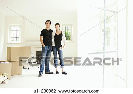 A young couple in a new home View Large Photo Image Stock Image - A young couple in a new home. Fotosearch