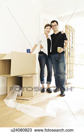 Stock Image - A young couple in their new home. Fotosearch