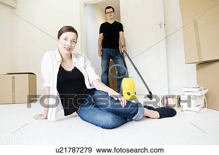 Stock Photo - A young couple with cardboard boxes. Fotosearch
