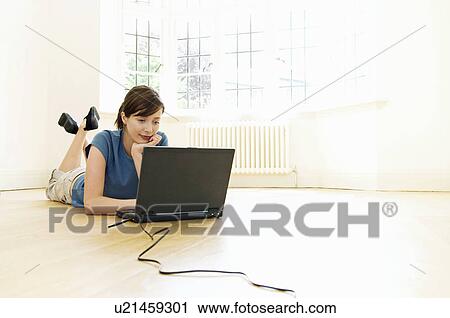Stock Image - A young female on her laptop. Fotosearch