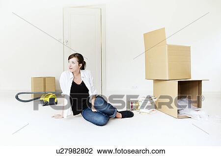 Stock Image - A young female with cardboard boxes. Fotosearch