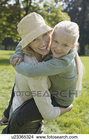 A young girl and her mother in the park View Large Photo Image Picture - A young girl and her mother in the park. Fotosearch