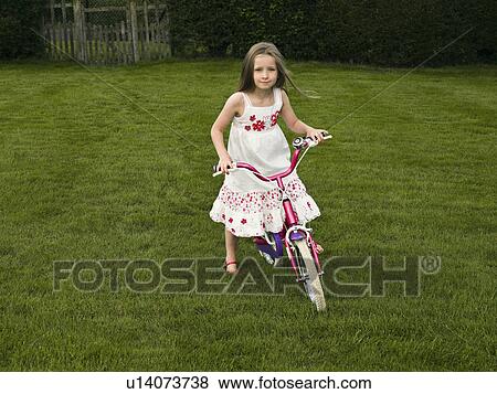 A young girl on a bike View Large Photo Image Stock Photo - A young girl on a bike. Fotosearch