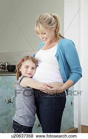 A young pregnant mum with her daughter View Large Photo Image Stock Photo - A young pregnant mum with her daughter. Fotosearch