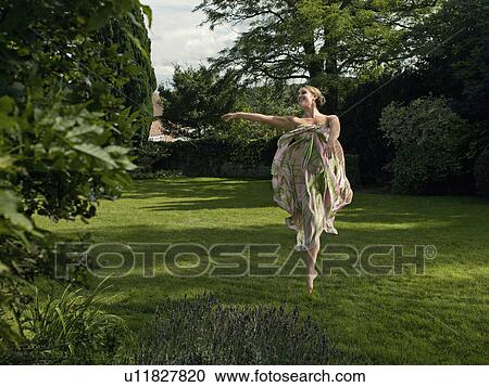 A young woman dancing in a garden View Large Photo Image Stock Image - A young woman dancing in a garden. Fotosearch