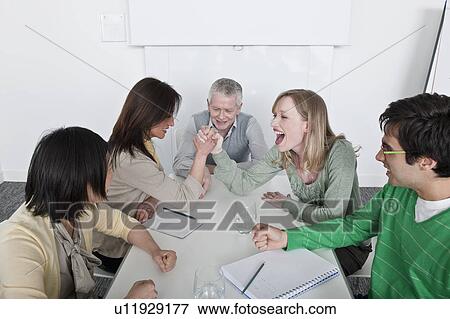 Stock Photo - arm wrestling in group meeting. Fotosearch