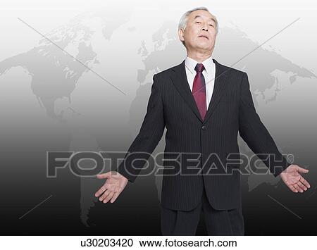 Asian man standing in front of world map View Large Photo Image Stock Image - Asian man standing in front of world map. Fotosearch