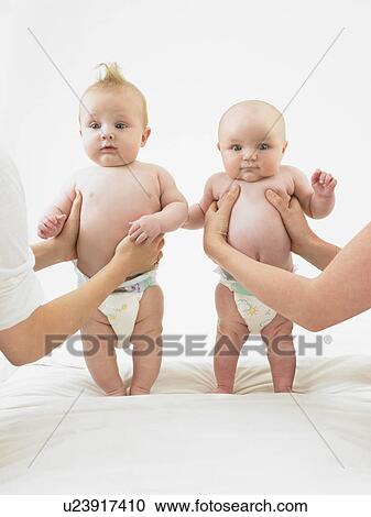 Stock Image - babies standing with help. Fotosearch