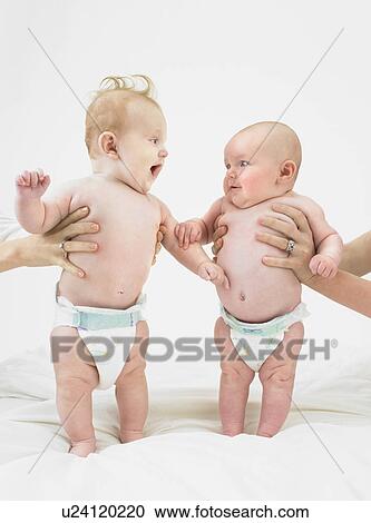 babies standing with help View Large Photo Image Stock Image - babies standing with help. Fotosearch
