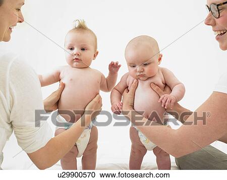 babies standing with help View Large Photo Image Stock Image - babies standing with help. Fotosearch