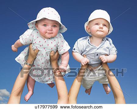 Stock Photo - babies up in the air. Fotosearch