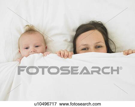 baby and mother in bed View Large Photo Image Stock Photo - baby and mother in bed. Fotosearch