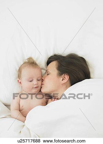 Stock Photo - baby and mother in bed. Fotosearch