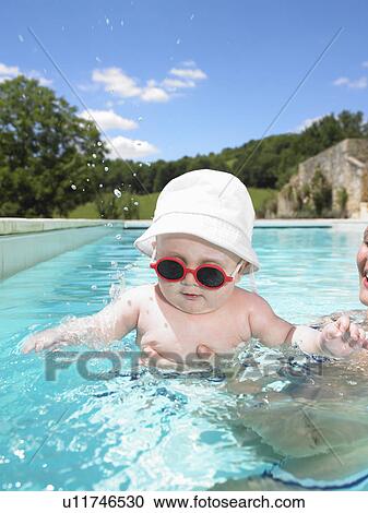 Stock Image - baby in pool. Fotosearch
