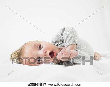 baby on white bed View Large Photo Image Stock Photo - baby on white bed. Fotosearch