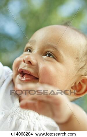 Picture - Baby smiling and playing. Fotosearch